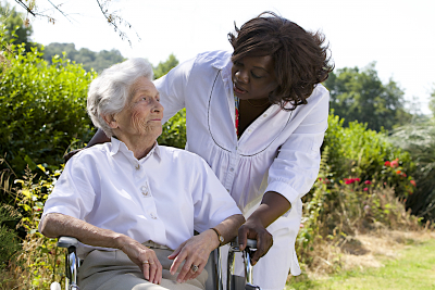 senior woman on a wheelchair with her caregiver